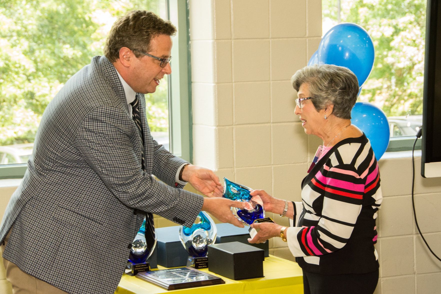 Andy Thorp, Executive Director of Miriam School presents Barbara Silver with her award at the Friends of Miriam Luncheon